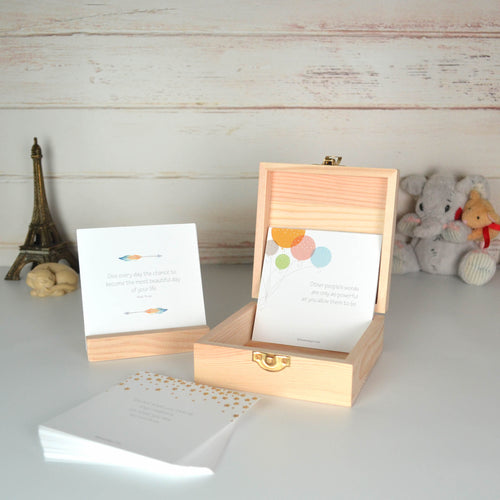 Gender neutral quote card box open, with the cards on display toy Eiffel tower , ceramic cat and stuffed toy