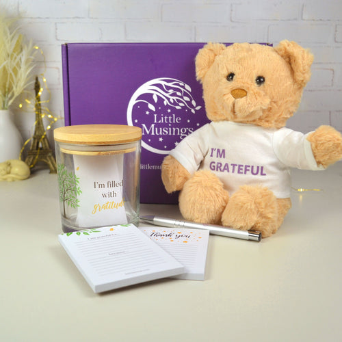 Kids gratitude jar on display with teddy and box