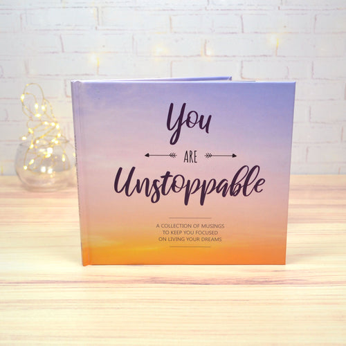 You are unstoppable book on display with fairy lights