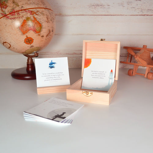 Boys teenagers and teens quote card box open, with the cards on display with globe and toy plane